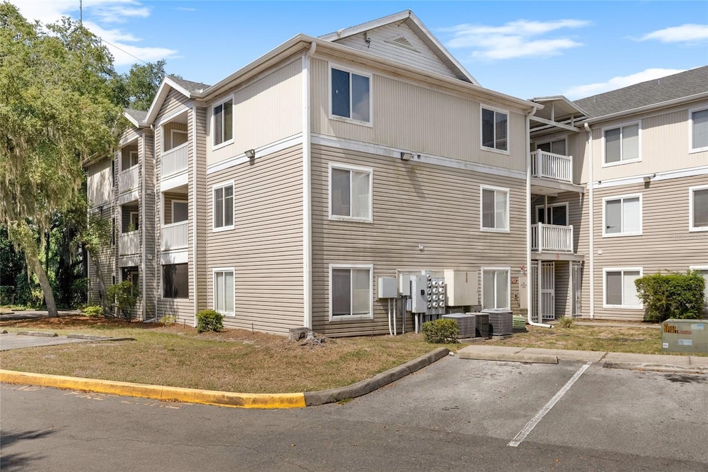 view of building exterior with uncovered parking