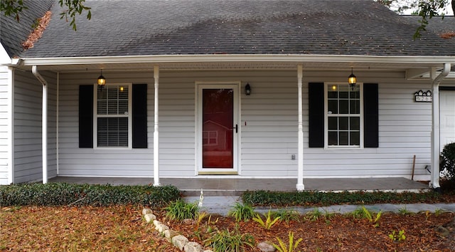 view of exterior entry with a porch