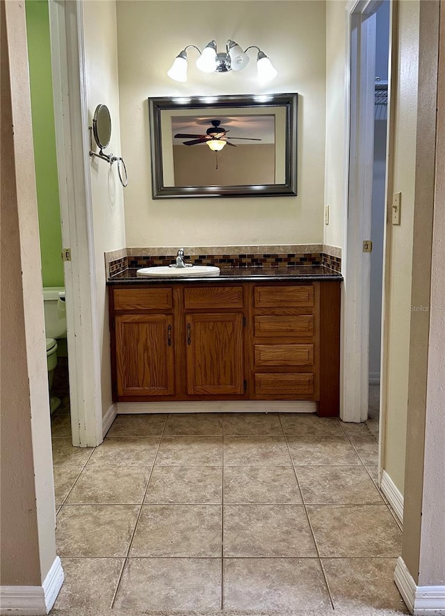 bathroom featuring vanity, ceiling fan, tile patterned flooring, and toilet