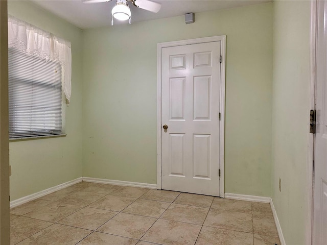 spare room with light tile patterned floors and ceiling fan