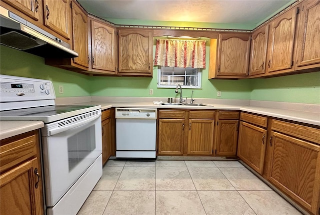 kitchen featuring sink, white appliances, and light tile patterned floors