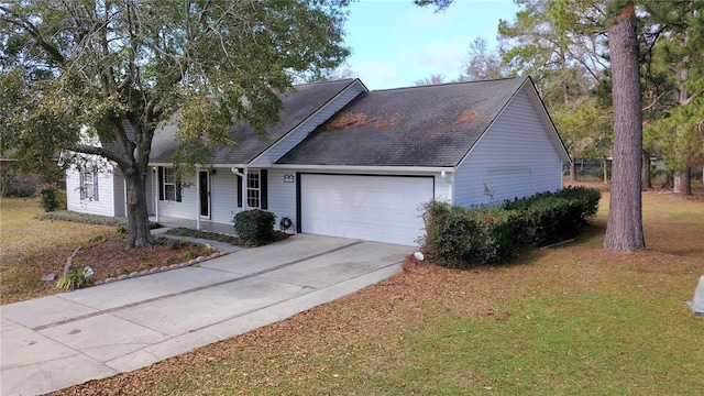 view of front of property with a garage and a front yard