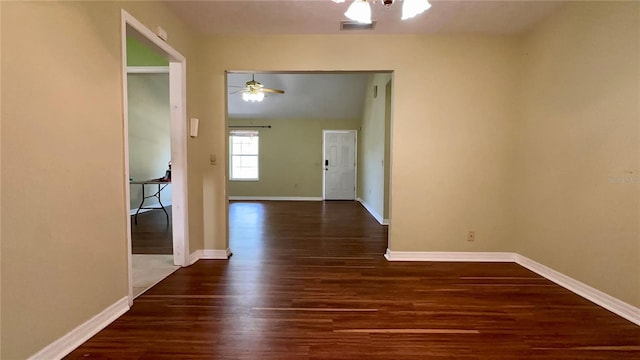 interior space featuring dark wood-type flooring and ceiling fan