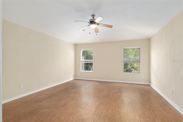 spare room featuring hardwood / wood-style flooring and ceiling fan