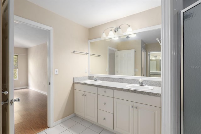 bathroom with wood-type flooring, vanity, and a shower with shower door