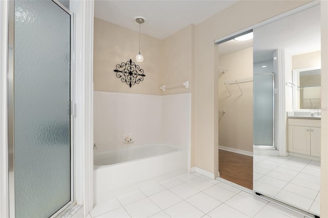 bathroom featuring tile patterned floors, vanity, and plus walk in shower