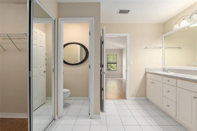 bathroom featuring vanity, toilet, and wood-type flooring