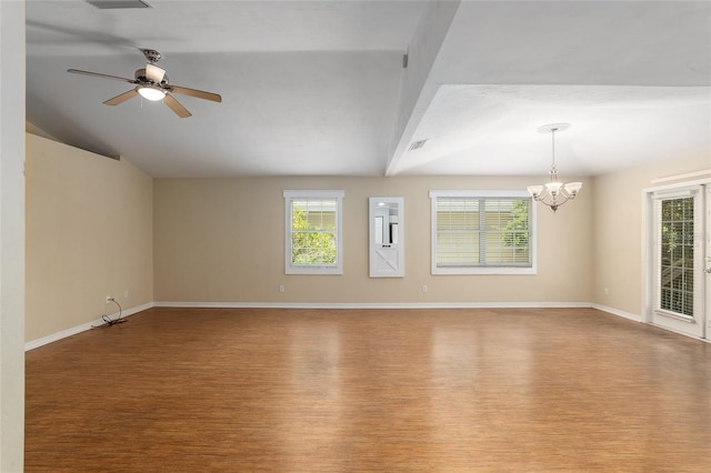 spare room with wood-type flooring, ceiling fan with notable chandelier, and vaulted ceiling