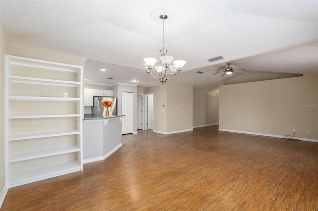 unfurnished living room with hardwood / wood-style floors, ceiling fan with notable chandelier, built in features, and lofted ceiling