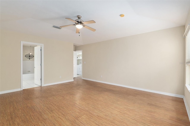 unfurnished room with ceiling fan, light hardwood / wood-style floors, and washer / dryer