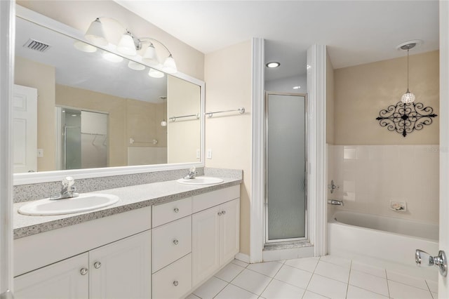 bathroom with tile patterned flooring, vanity, and shower with separate bathtub