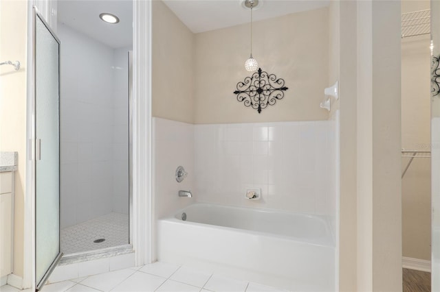 bathroom featuring tile patterned flooring and separate shower and tub