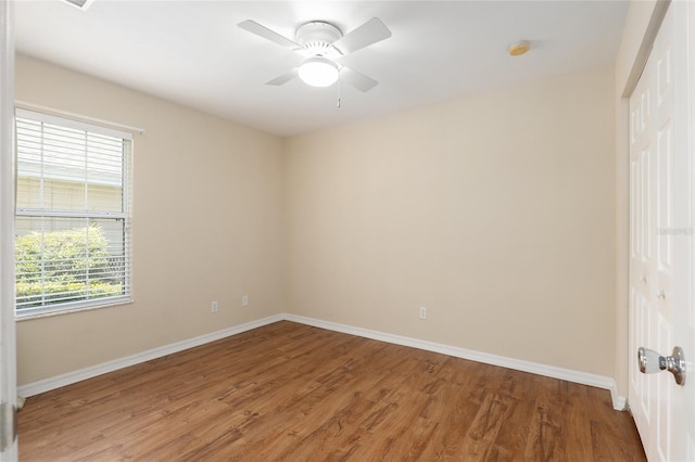 spare room featuring hardwood / wood-style flooring, plenty of natural light, and ceiling fan