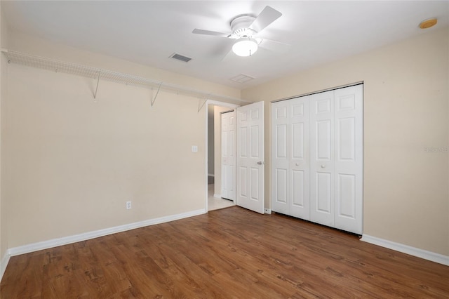 unfurnished bedroom featuring ceiling fan and dark hardwood / wood-style floors