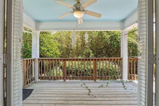 wooden deck featuring ceiling fan