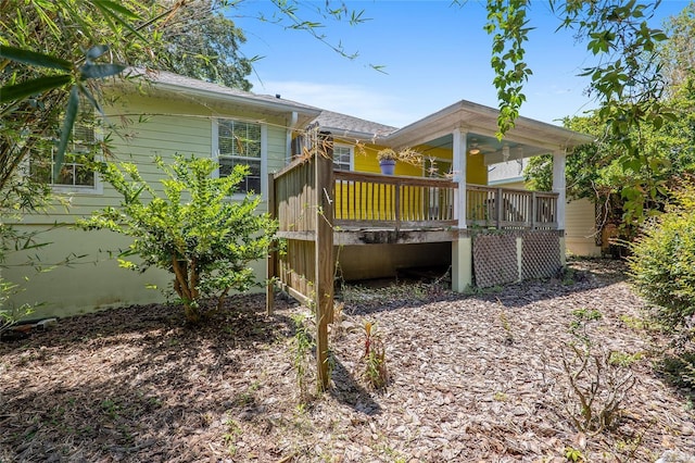 rear view of house featuring a wooden deck