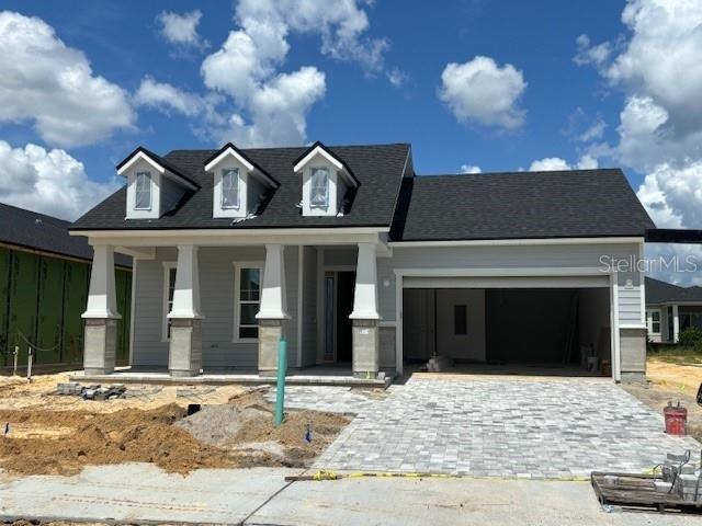 view of front of house featuring a porch and a garage