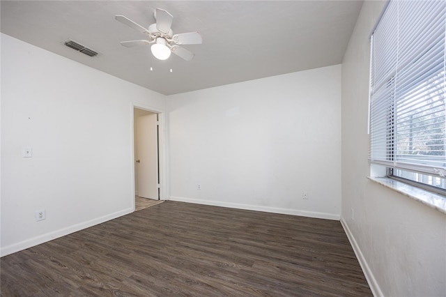 spare room featuring ceiling fan and dark hardwood / wood-style floors