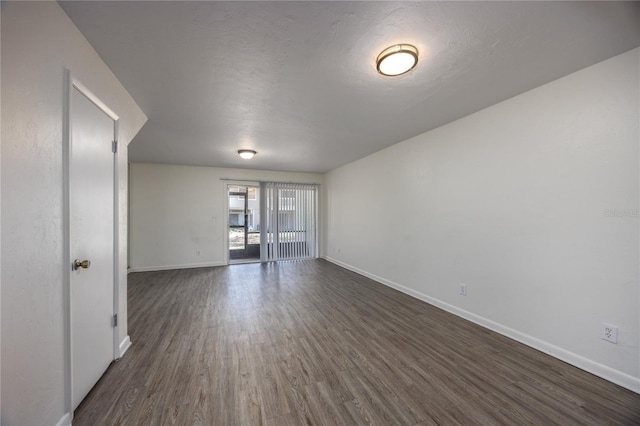 spare room with dark wood-type flooring