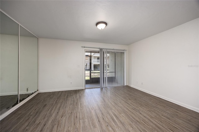 unfurnished room with dark hardwood / wood-style floors