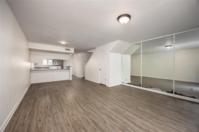 unfurnished living room featuring dark hardwood / wood-style flooring