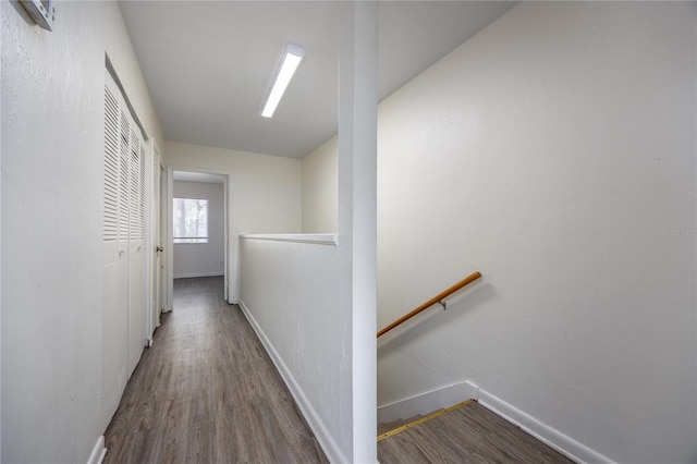 corridor with hardwood / wood-style flooring