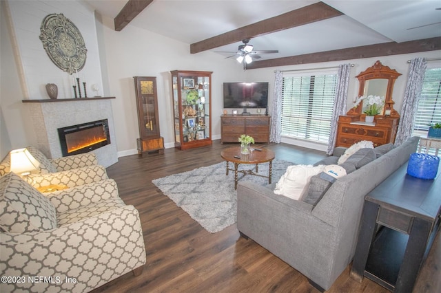 living area featuring ceiling fan, a tile fireplace, baseboards, beam ceiling, and dark wood-style floors