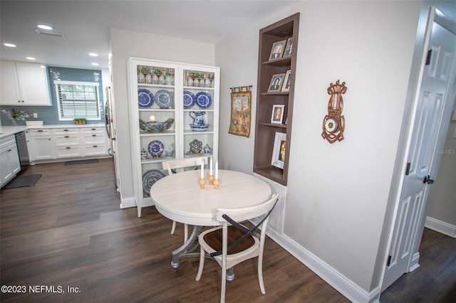 dining room featuring baseboards, dark wood-type flooring, and recessed lighting