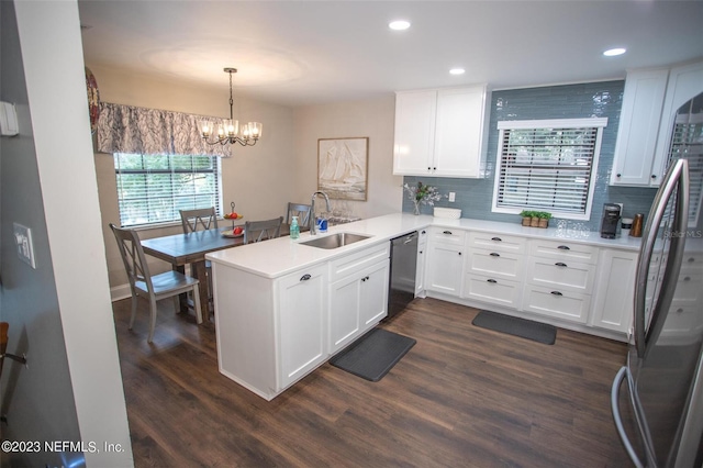 kitchen featuring a peninsula, appliances with stainless steel finishes, light countertops, and white cabinets