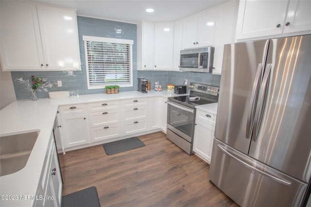 kitchen featuring stainless steel appliances, dark wood-type flooring, and white cabinetry