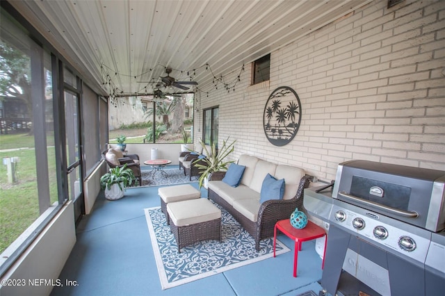 sunroom featuring wood ceiling and a ceiling fan