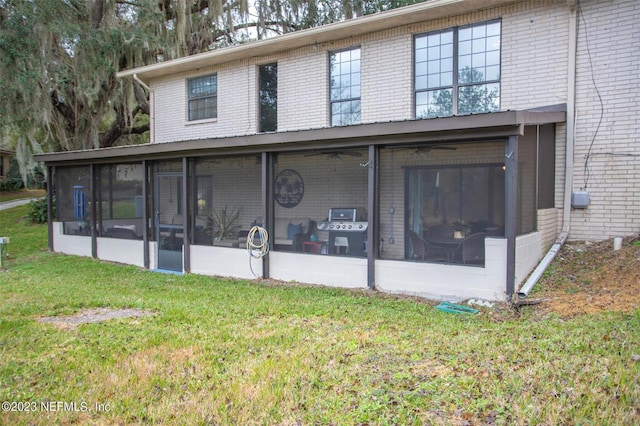 view of front facade with a sunroom and a front lawn