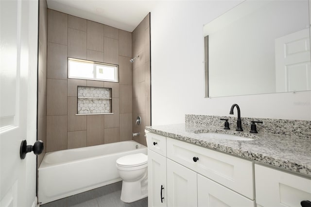 full bathroom with tile patterned flooring, vanity, toilet, and tiled shower / bath