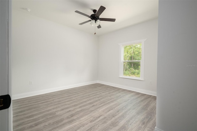 unfurnished room with hardwood / wood-style flooring and ceiling fan