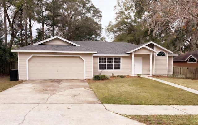 ranch-style house featuring a front lawn and a garage