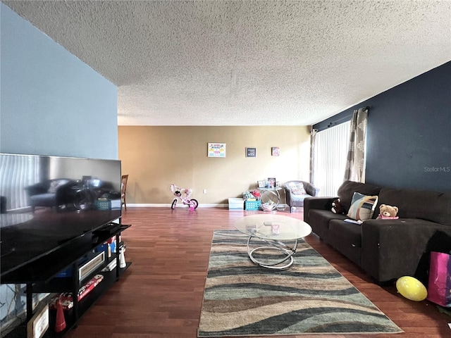 living room with dark hardwood / wood-style flooring and a textured ceiling