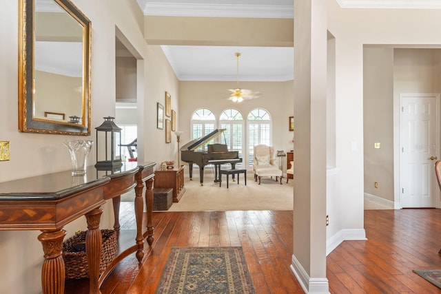 foyer with wood-type flooring, ceiling fan, and ornamental molding