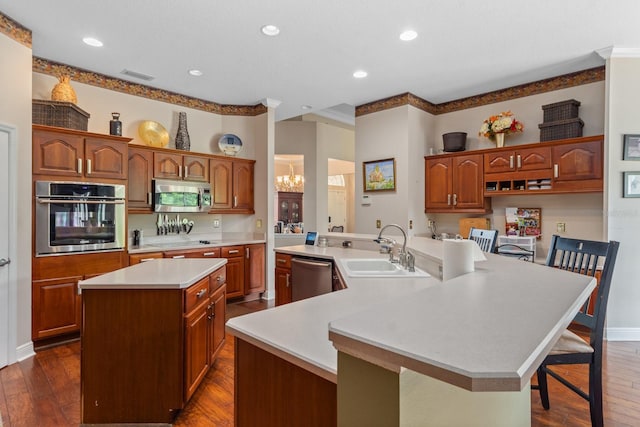 kitchen featuring a kitchen breakfast bar, a spacious island, sink, a notable chandelier, and stainless steel appliances