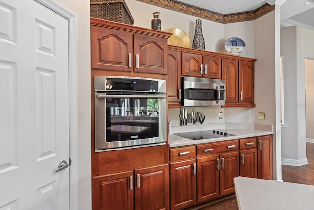 kitchen featuring ornamental molding and appliances with stainless steel finishes