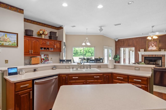 kitchen featuring ceiling fan, dishwasher, sink, a brick fireplace, and ornamental molding