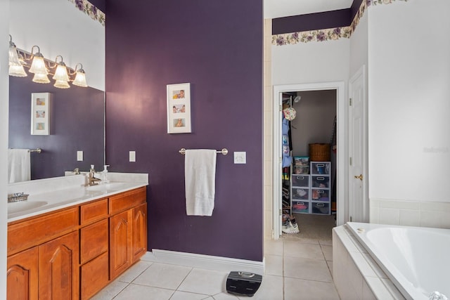 bathroom featuring tile patterned floors, tiled bath, and vanity