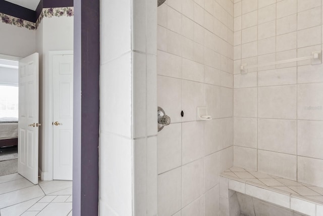 bathroom featuring a tile shower and tile patterned flooring