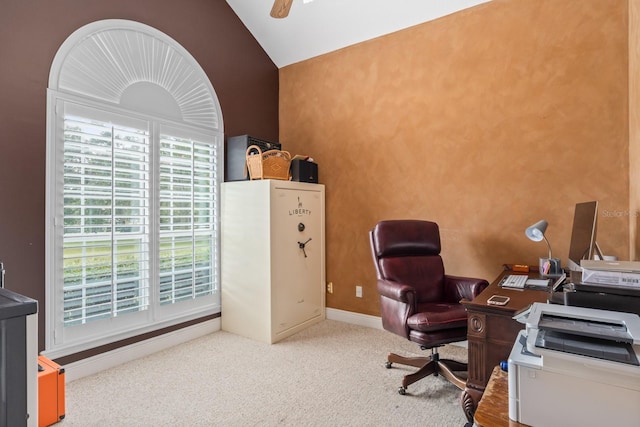 carpeted home office featuring vaulted ceiling and ceiling fan