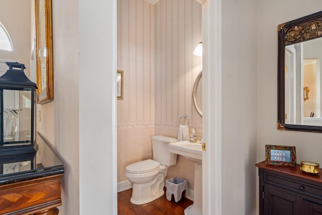 bathroom featuring toilet, wood-type flooring, and tile walls