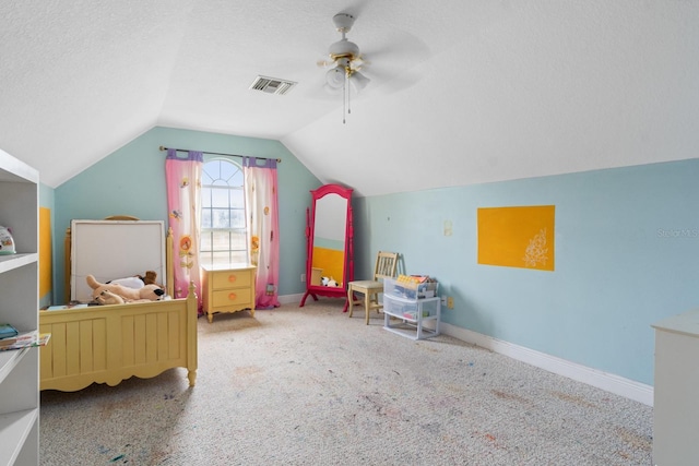 playroom featuring ceiling fan, carpet floors, a textured ceiling, and lofted ceiling