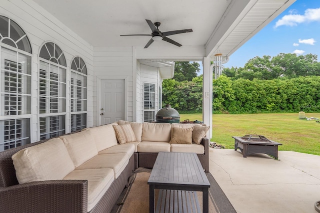 view of patio with ceiling fan and an outdoor living space with a fire pit