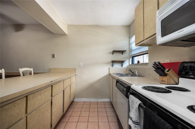 kitchen featuring light tile patterned floors, white appliances, and sink