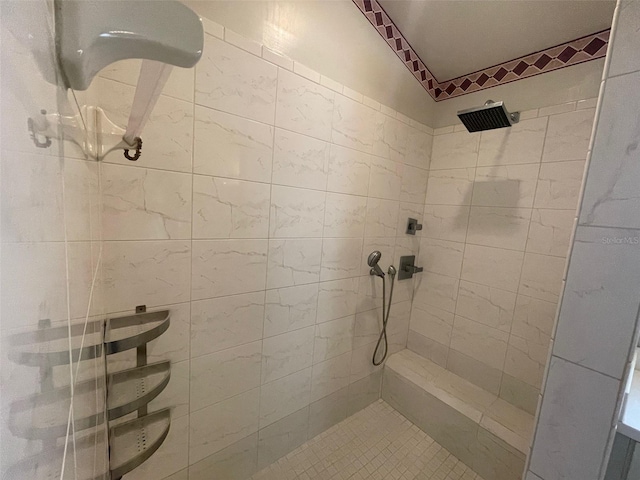 bathroom with a tile shower