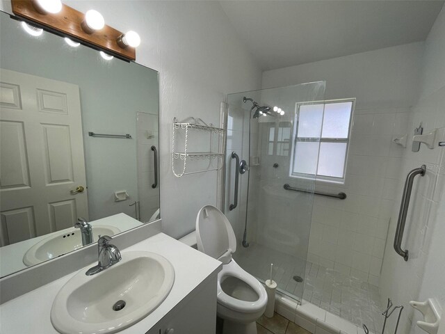 bathroom with vanity, toilet, and an enclosed shower