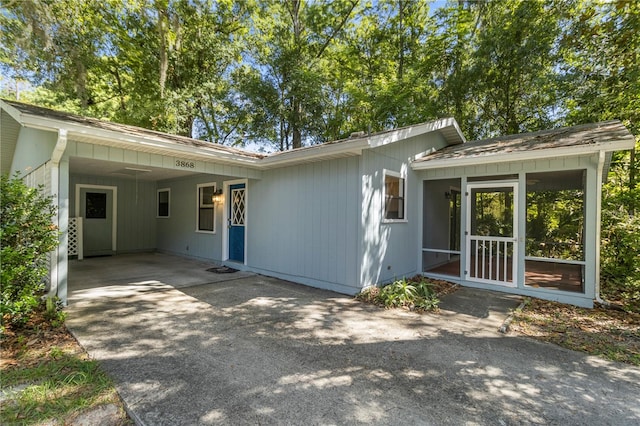 back of house featuring a carport